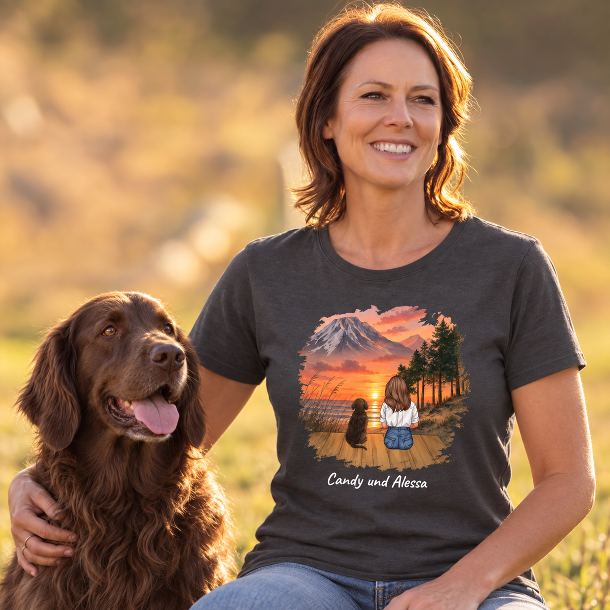T-shirt gris foncé avec motif personnalisé d'une femme et d'un chien devant un paysage de montagne.