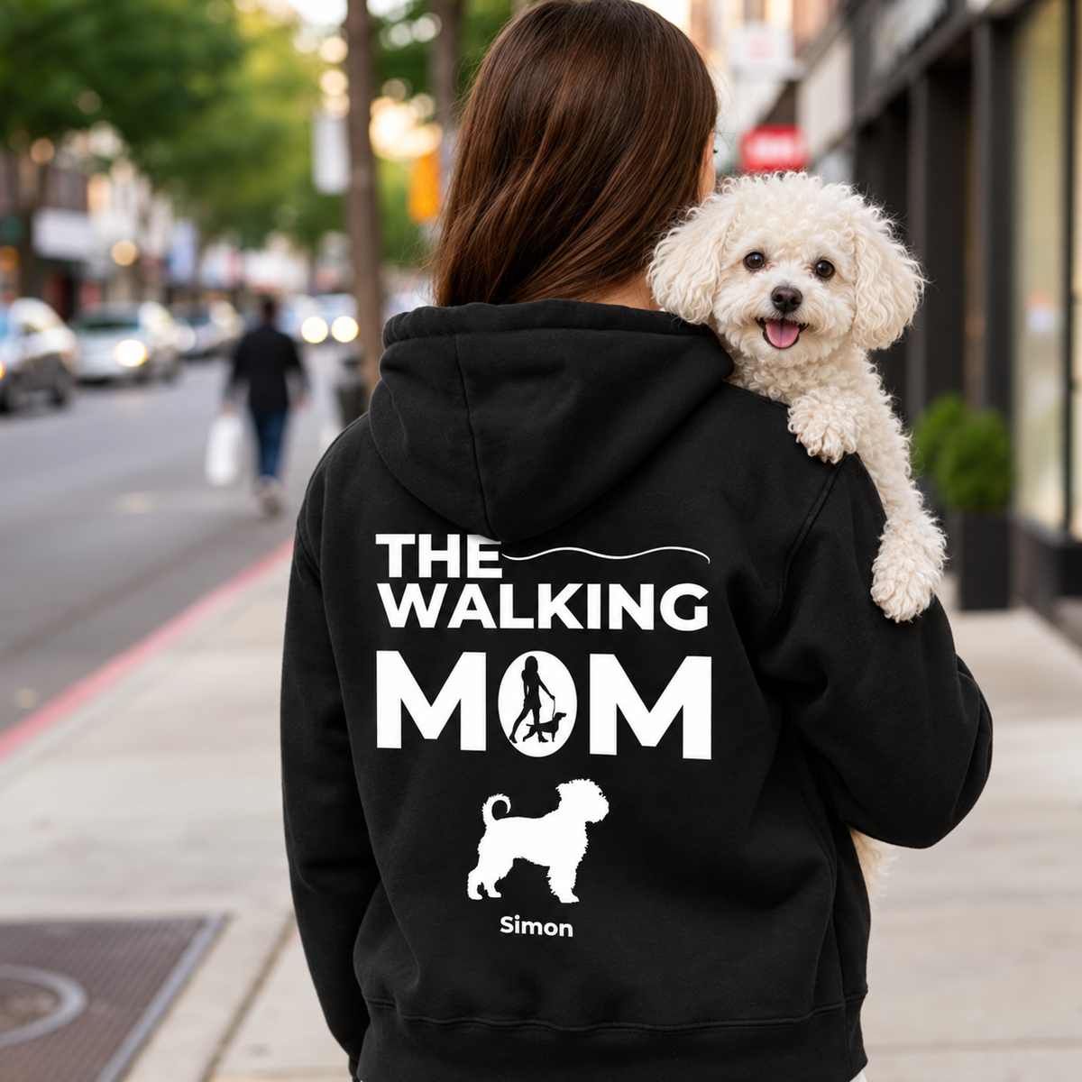 Sweat à capuche noir avec impression personnalisée "THE WALKING MOM" et motif de chien. Personne portant un chien.