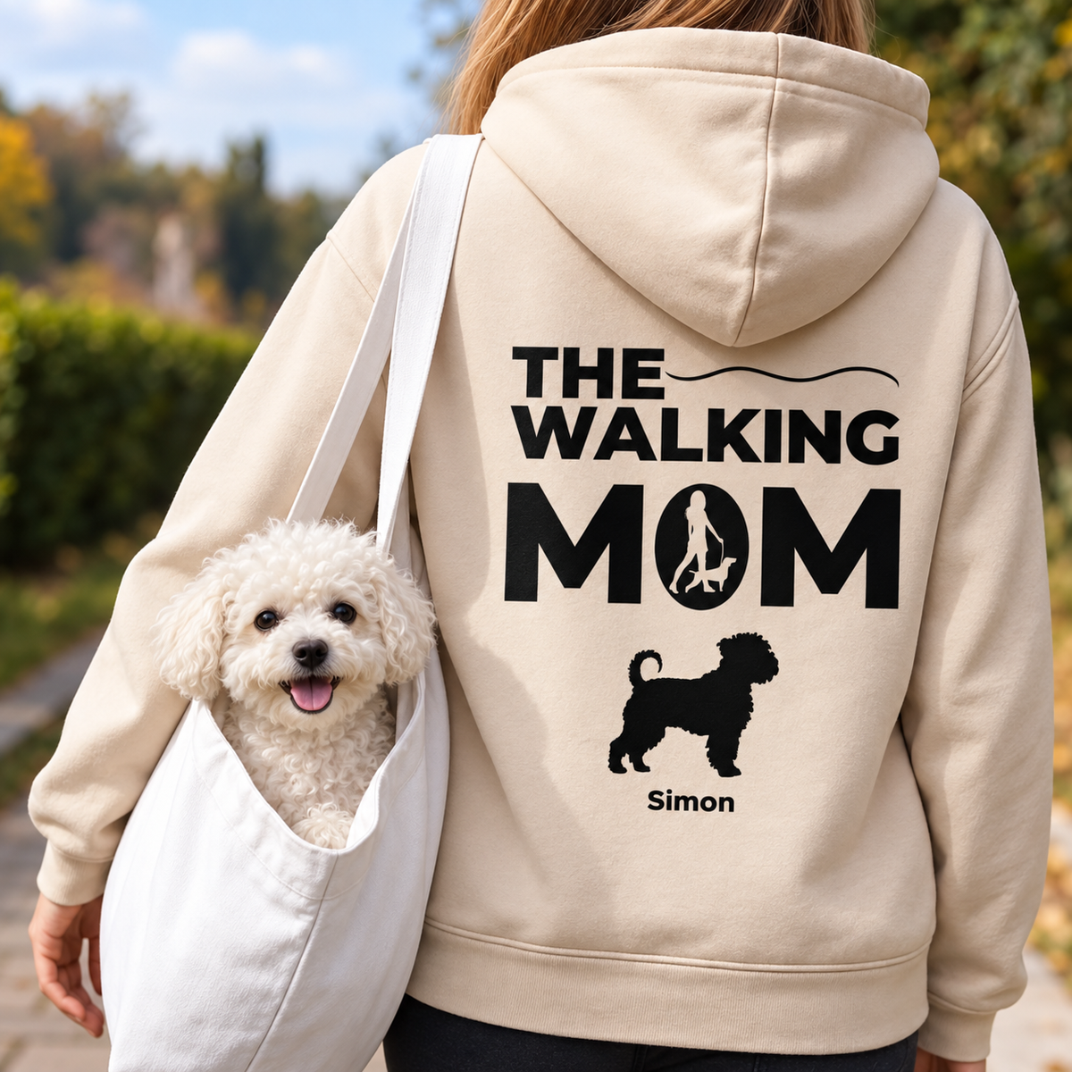 Sweat à capuche beige avec l'inscription "THE WALKING MOM" et motif de chien, porté par une personne avec un chien.